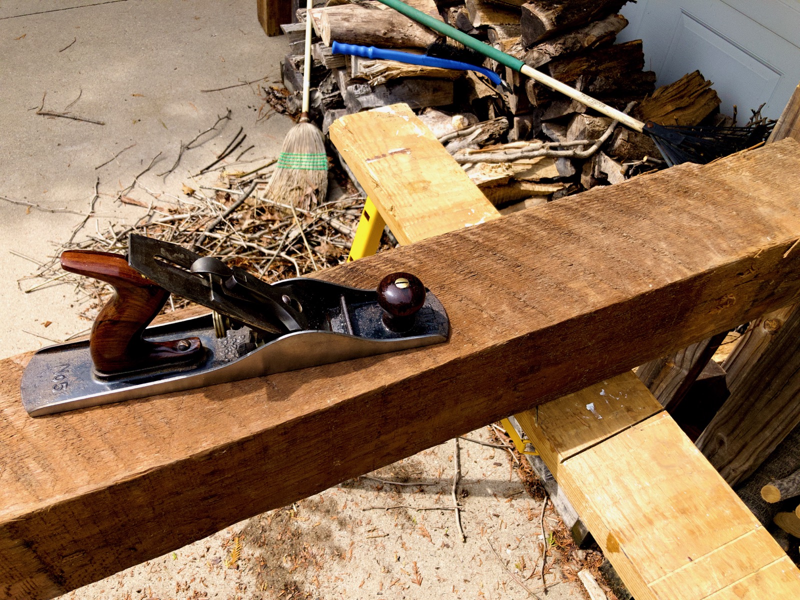 Close up of a barn beam and a handplane.