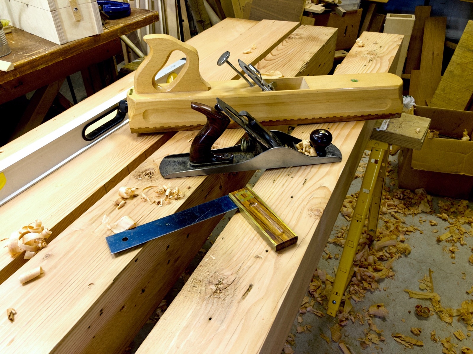 The beams for the top on a saw horse. Tools are on the beams.